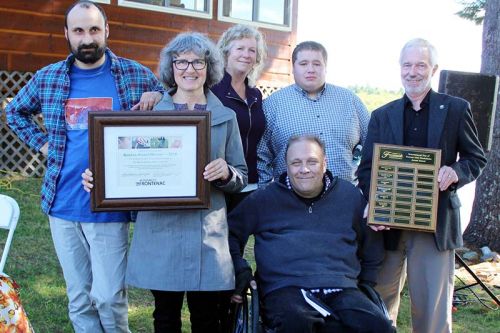 Dr. Karin Steiner of New Leaf Link accepts an Access Award from Warden Ron Higgins and Frontenac County accessibility advisory committee chair Neil Allen. Also in the photo are Julia Atherley, Nicolas Bell and Keifer Blight.